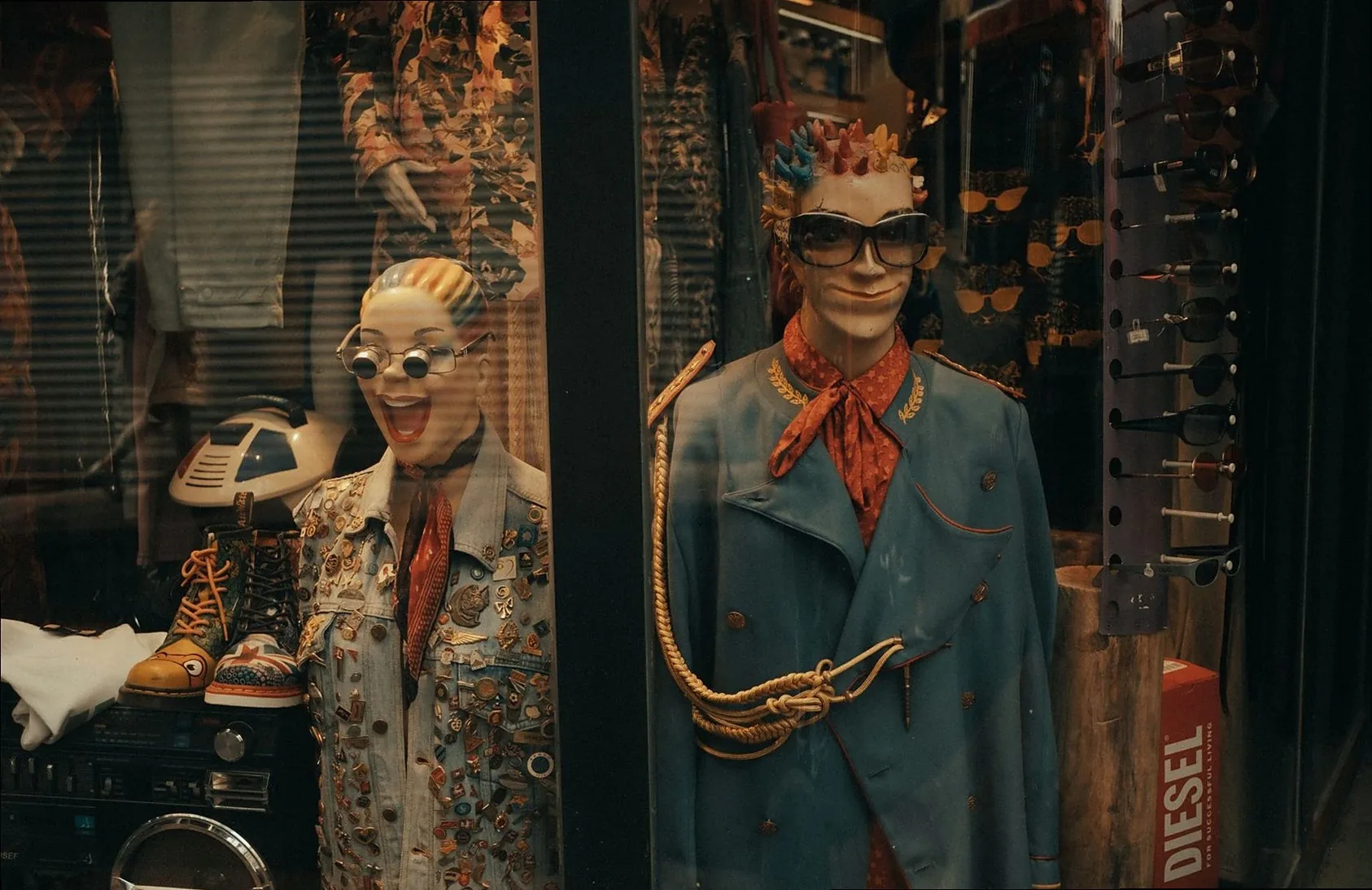 Quirky mannequins adorned in eclectic fashion pieces inside a vibrant store display.